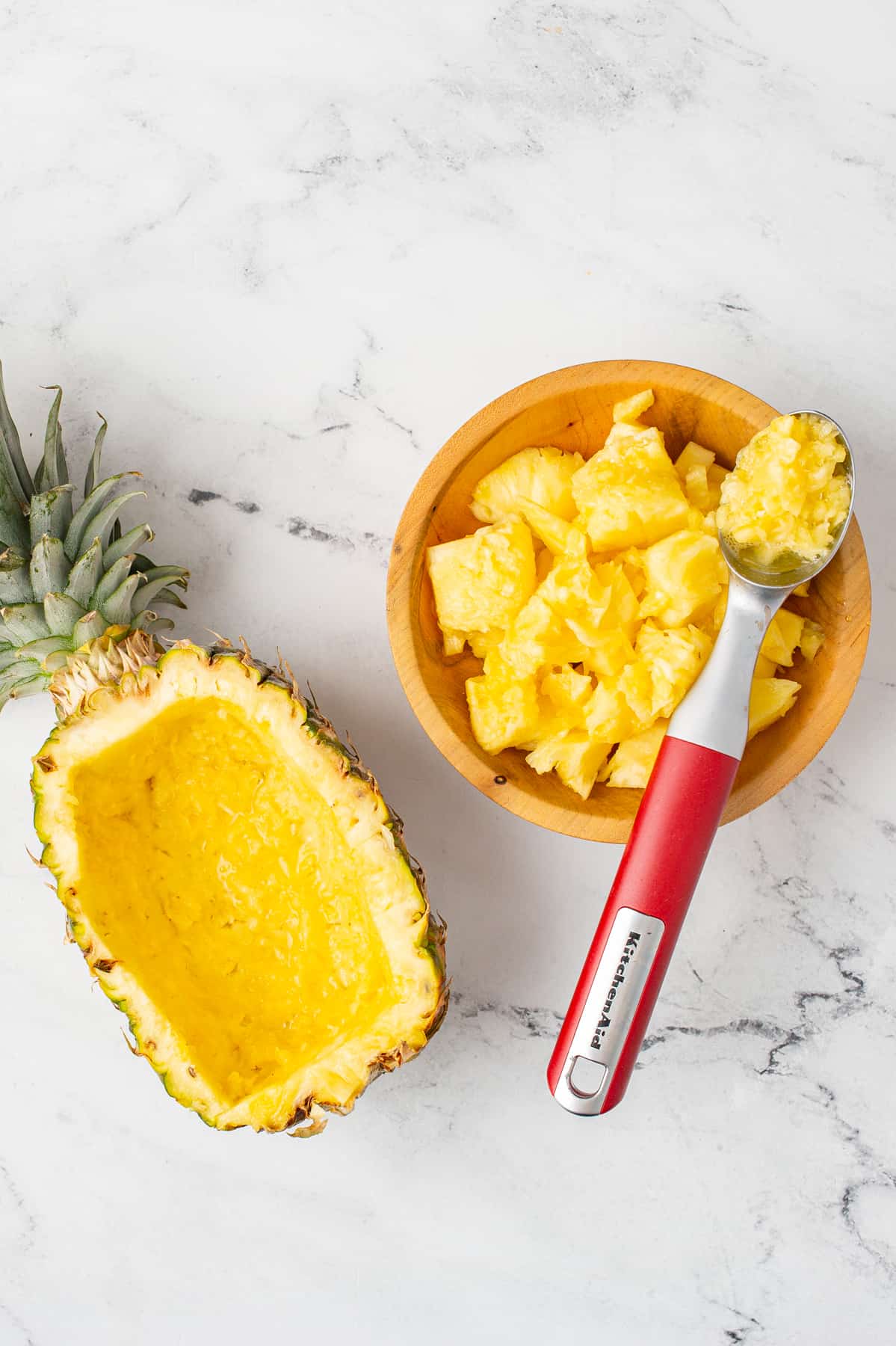 Pineapple Fruit Dip - pineapple being scooped out to use as a platter for fruit dip. 