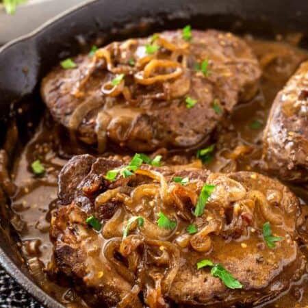Pan-Seared Filet Mignon with Shallot Mustard Gravy in a cast iron pan.