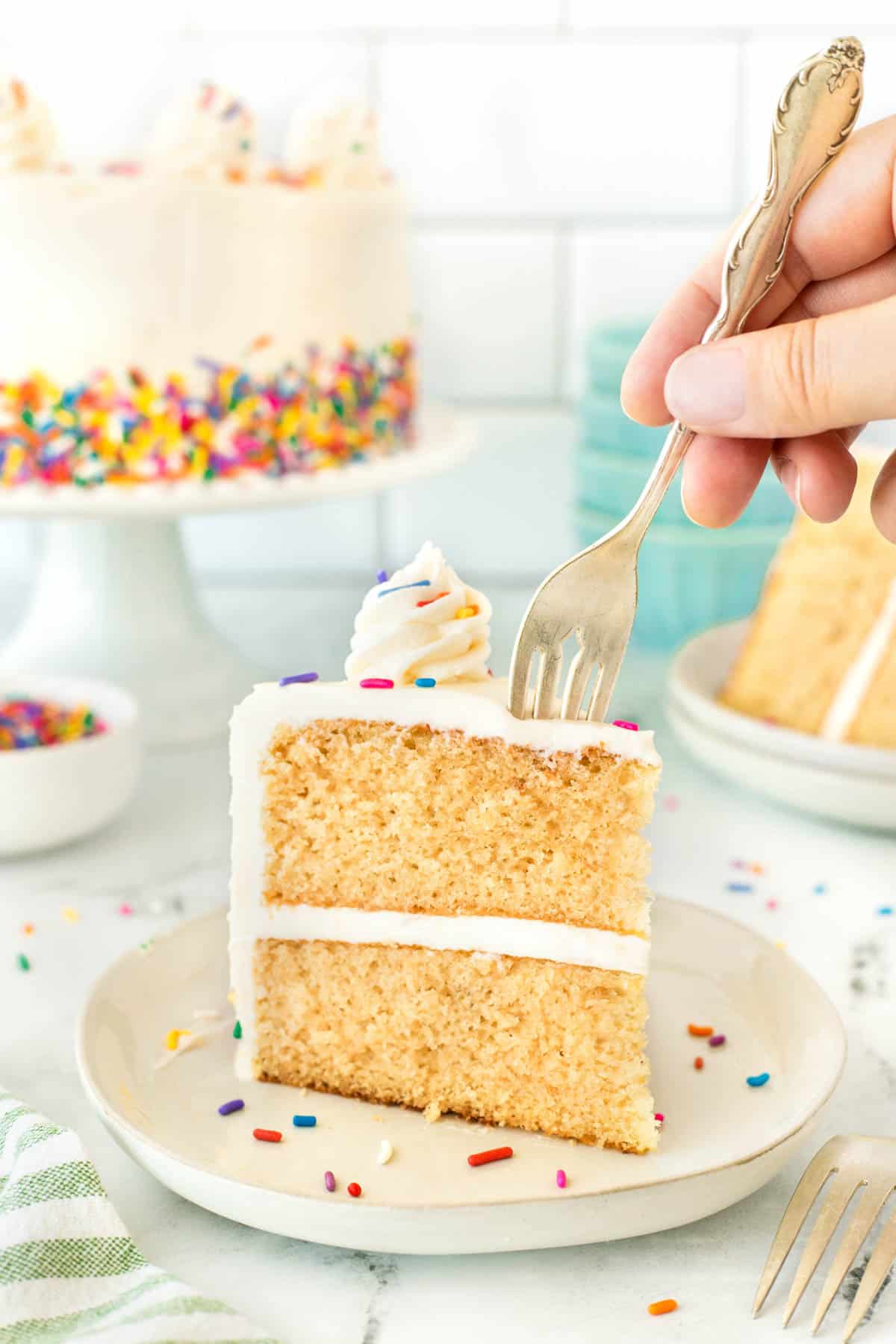 Sticking a fork into a slice of cake. 