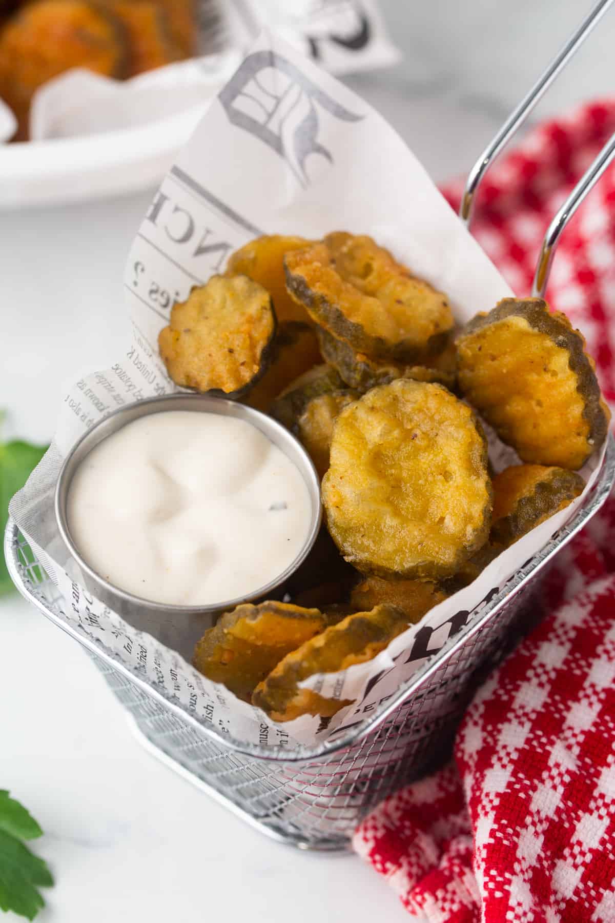 french fry basket holding deep fried pickle chips