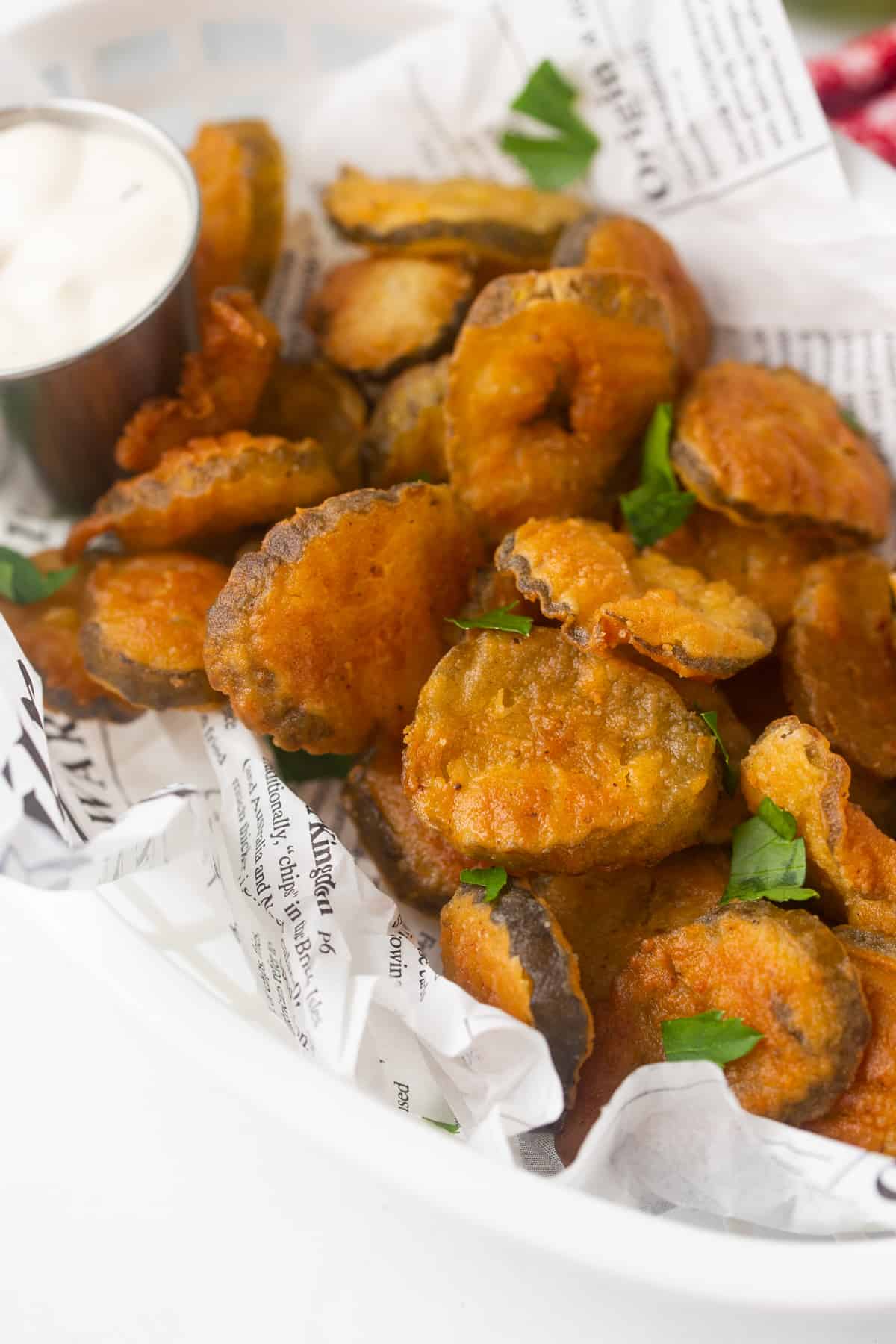 Golden brown pickle chips in a serving basket.