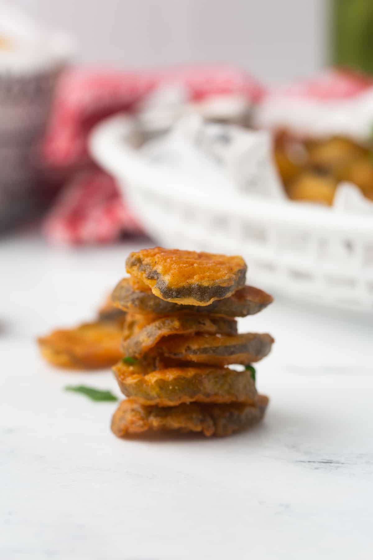 stack of golden brown dill pickle chips after being deep fried