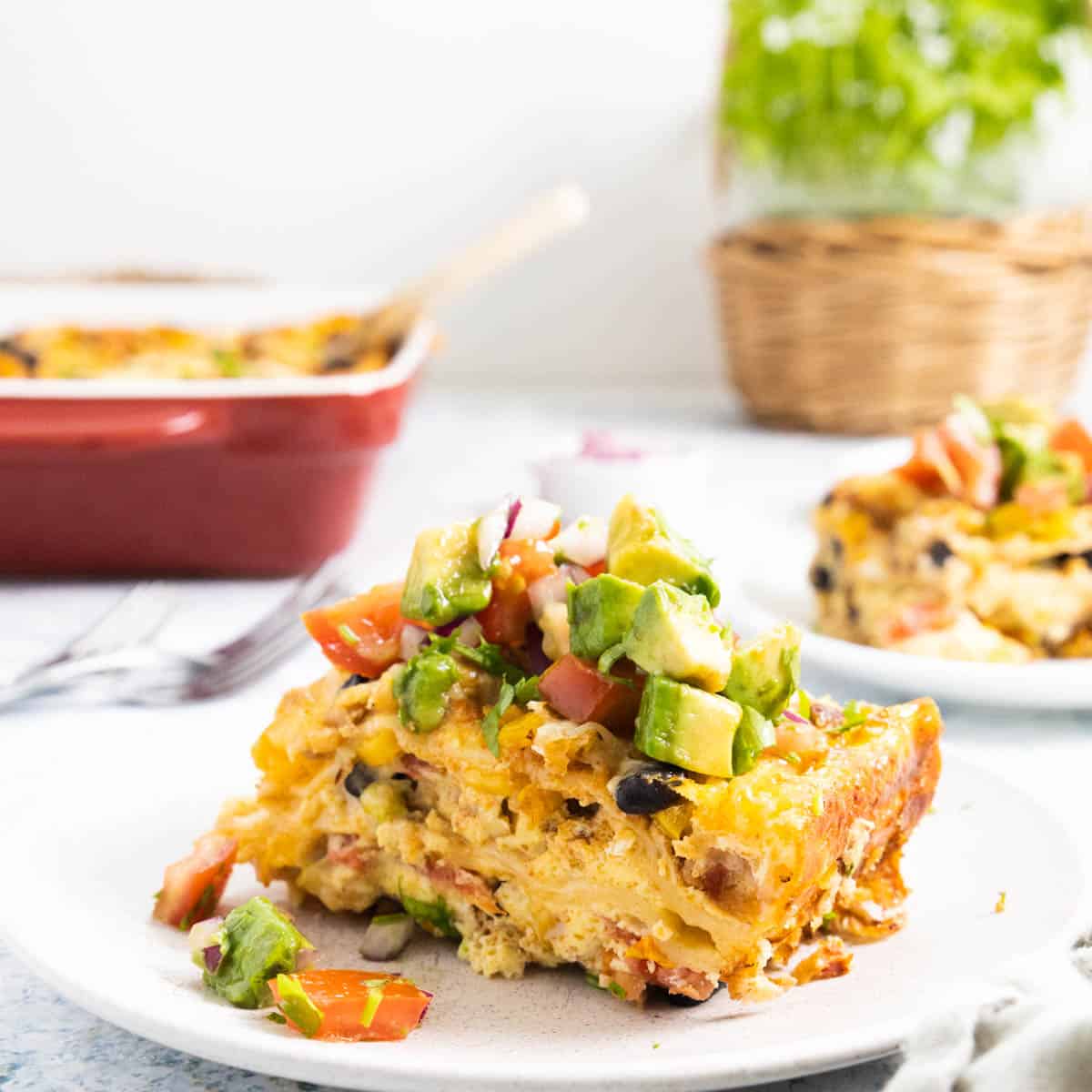 Large slice of Mexican Breakfast Casserole on a plate. 