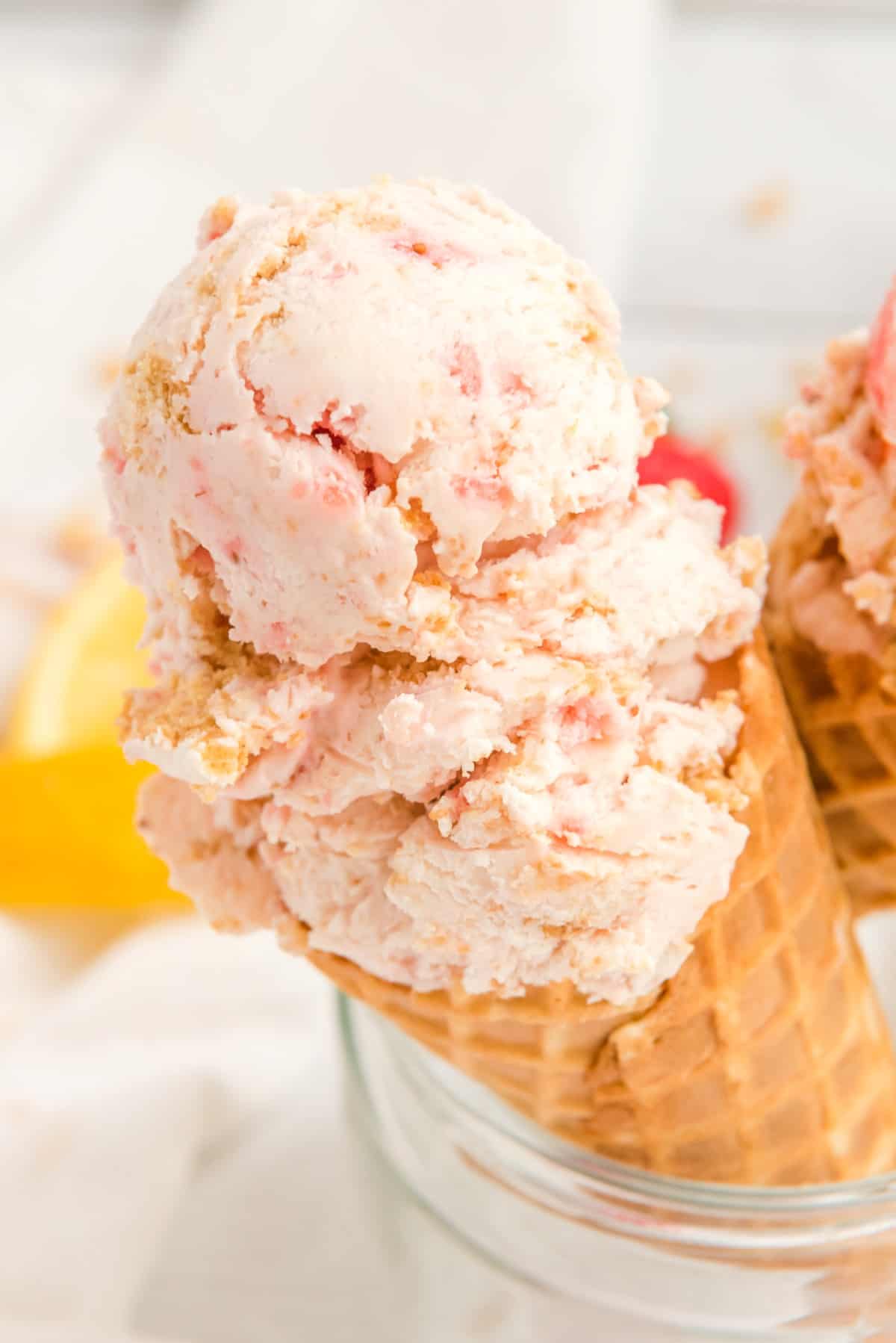 Ice cream cone of Lemon Strawberry Cheesecake Ice Cream. 