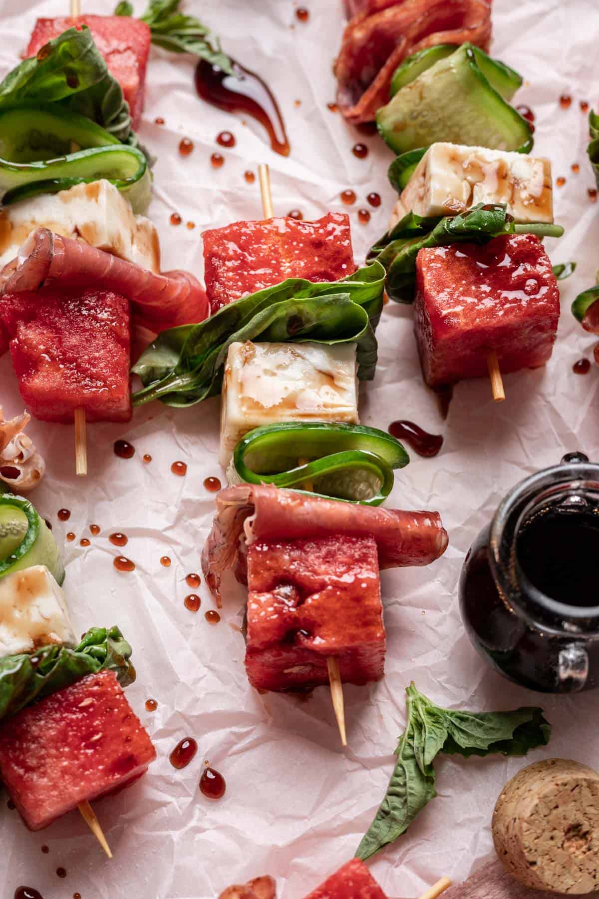 Front view of watermelon feta skewers drizzled with balsamic reduction. 