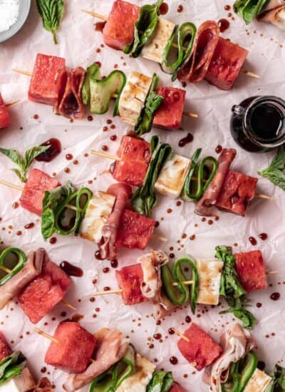 Overhead of watermelon feta skewers with a drizzle of balsamic reduction.