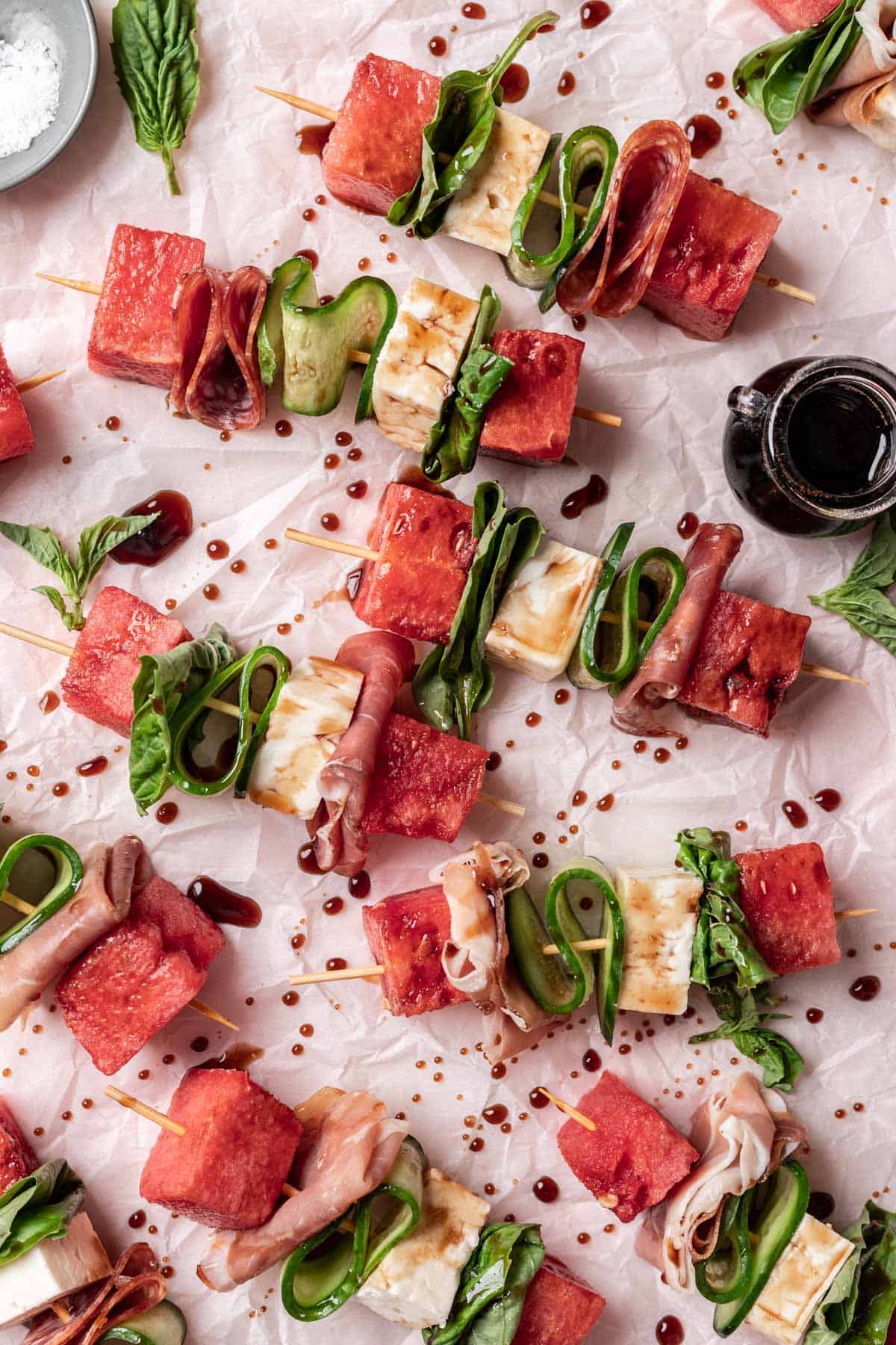 Overhead of watermelon feta skewers with a drizzle of balsamic reduction. 