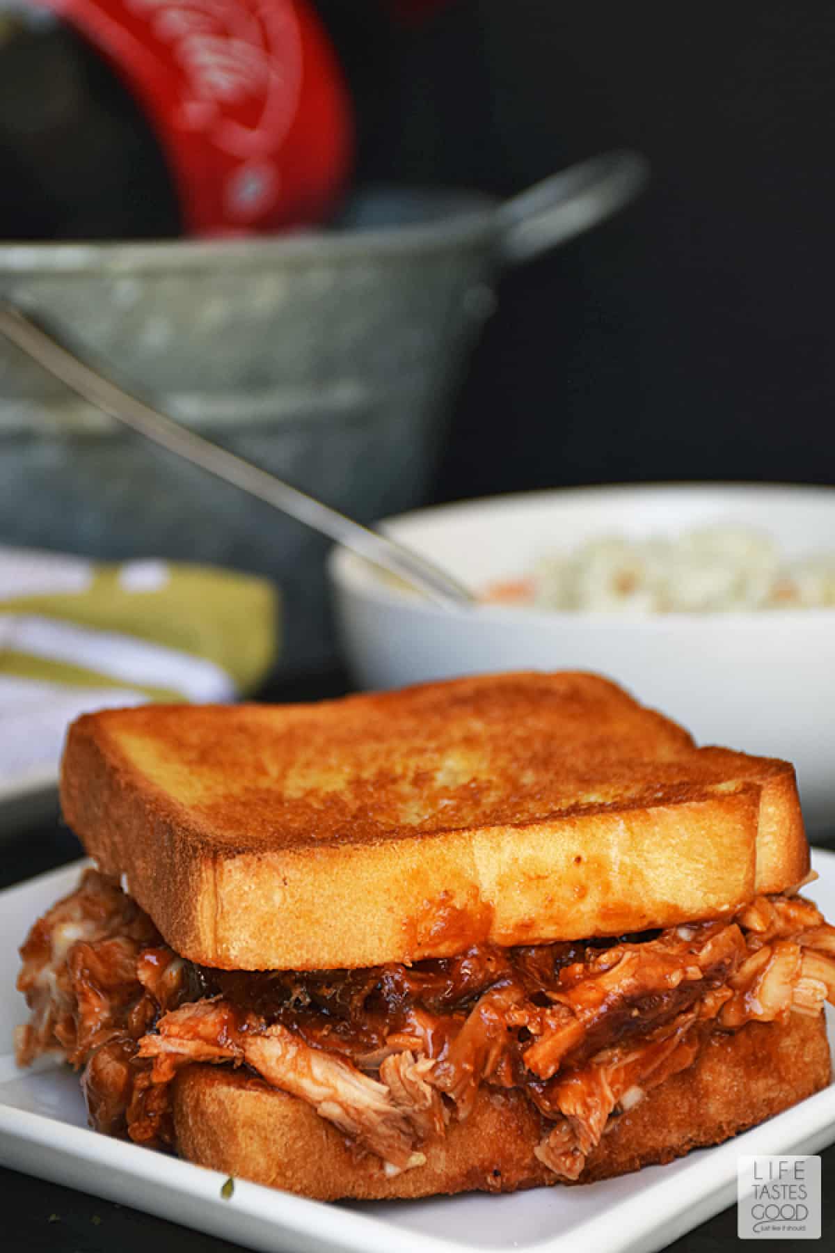 Barbecue chicken on garlic toast overflowing on a plate. 