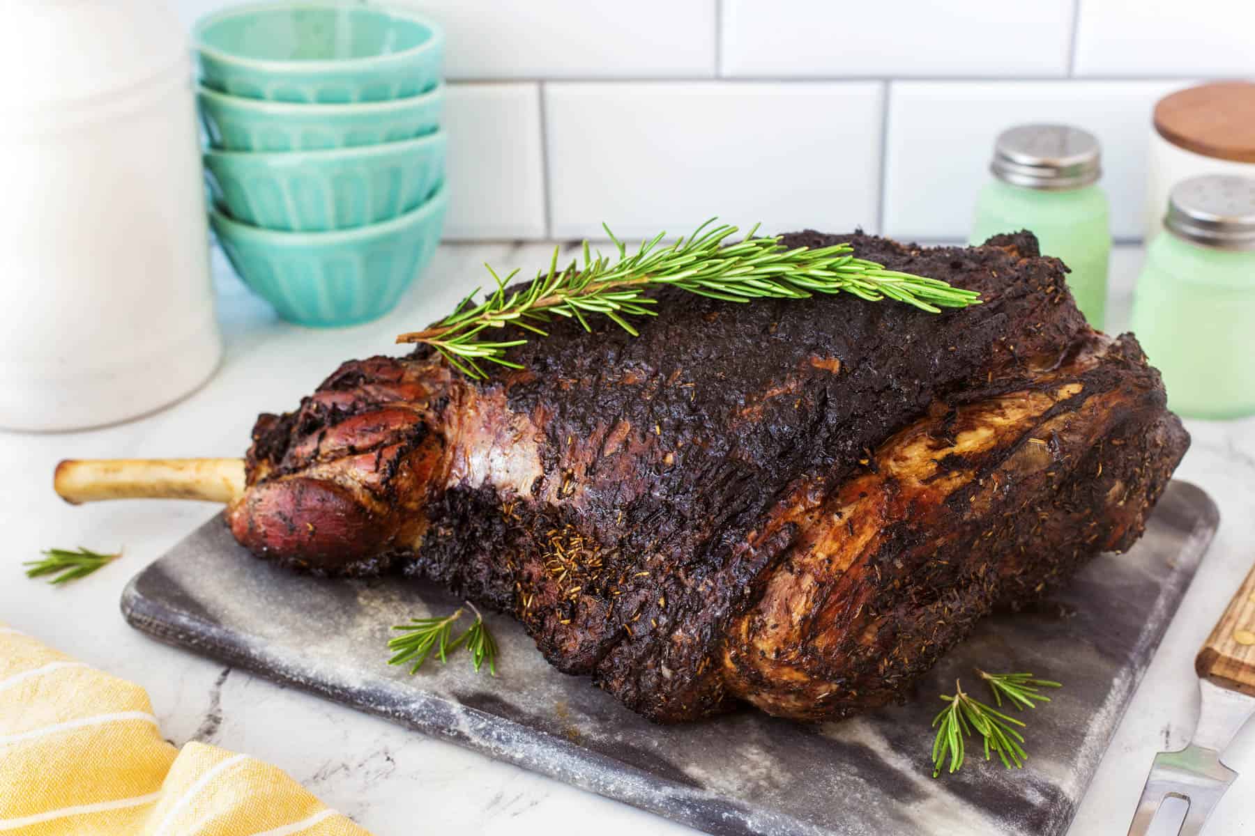 Leg of lamb resting on a cutting board. 