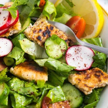 Close-up of Lebanese Fattoush Salad showing sumac on the vegetables.