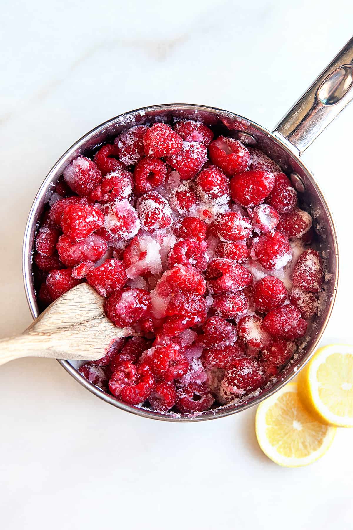 Raspberries and sugar in a pot. 
