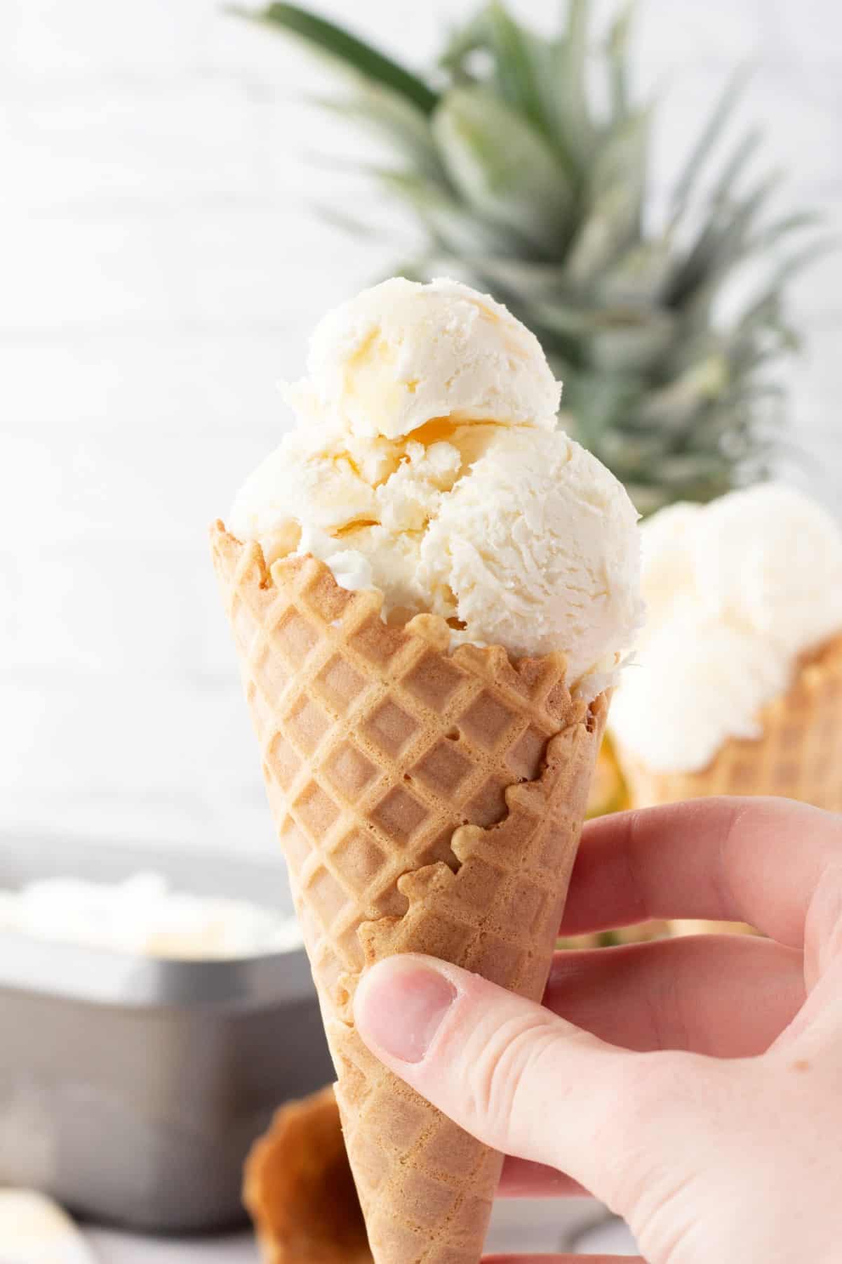 Holding an ice cream cone of Pineapple Coconut Ice Cream