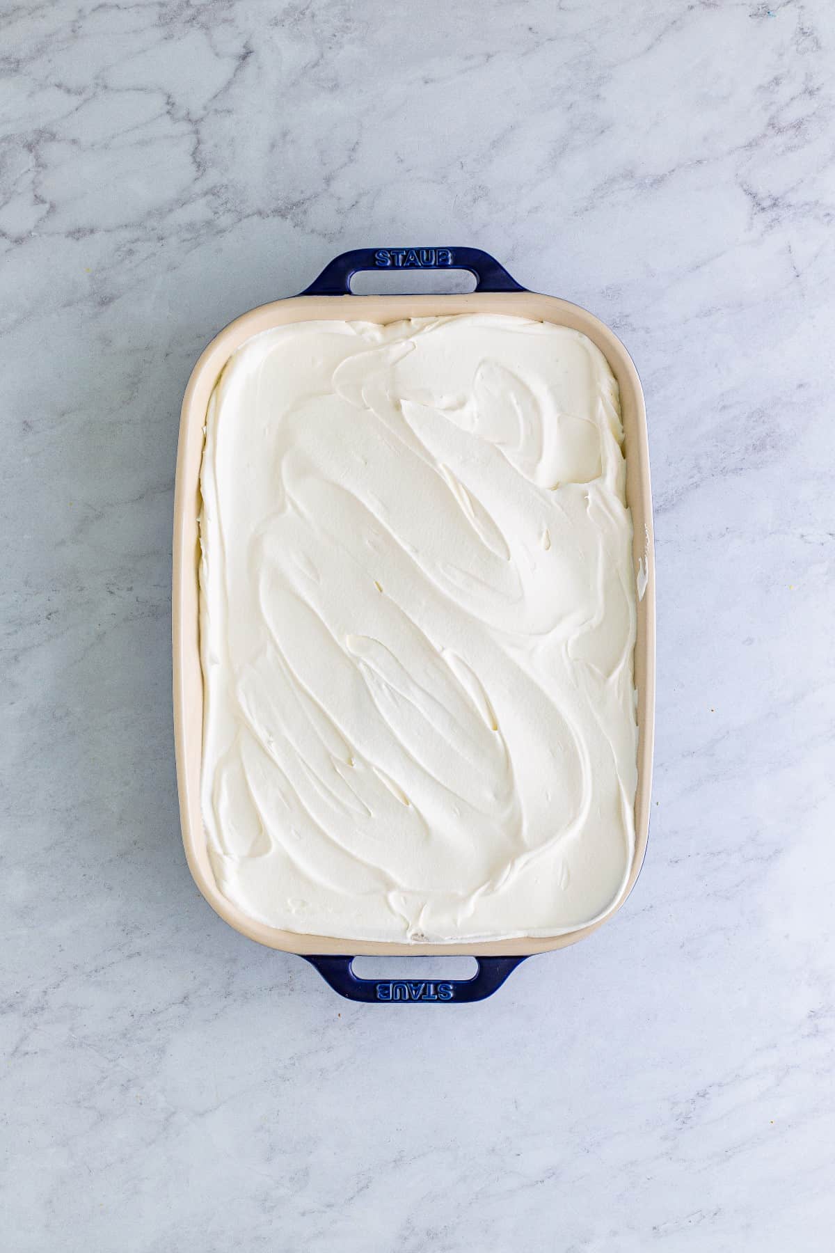 Overhead of Banana Icebox Cake with the final layer of whipped topping. 
