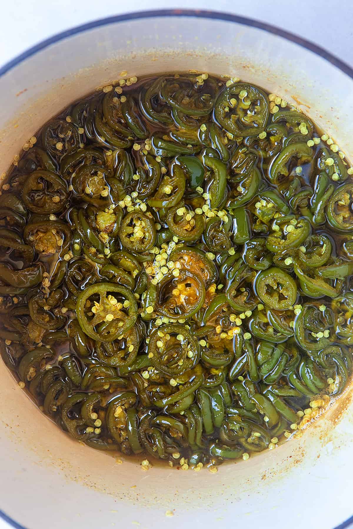 Overhead of a potful of candied jalapenos