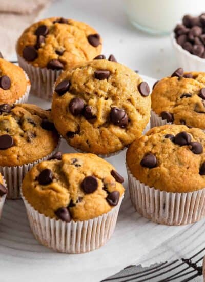 Banana Chocolate Chip Muffins on a cooling rack with one tilted forward.