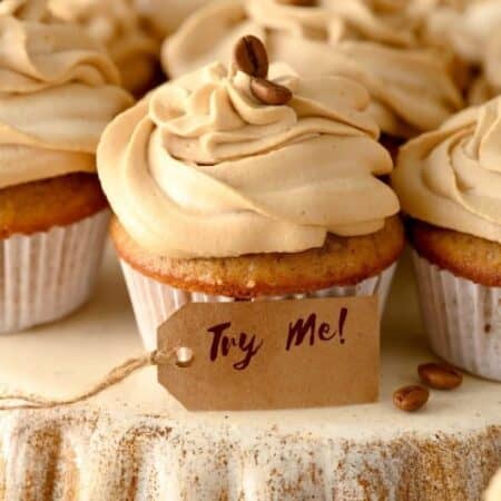 Coffee cupcakes on an upside down pie pan with a try me tag in front.