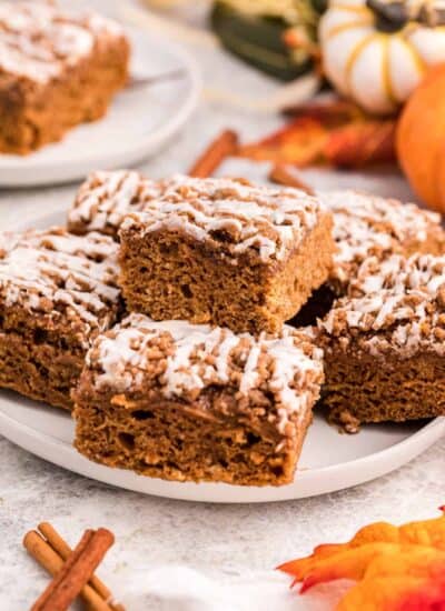 Squares of pumpkin coffee cake on a plate.