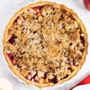 Overhead of an apple cranberry pie with crumb topping.