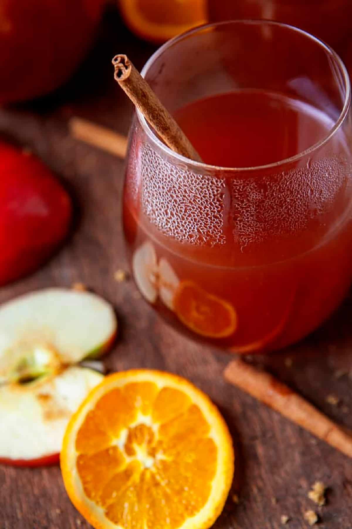 Apple Cider in a glass with a cinnamon stick. 