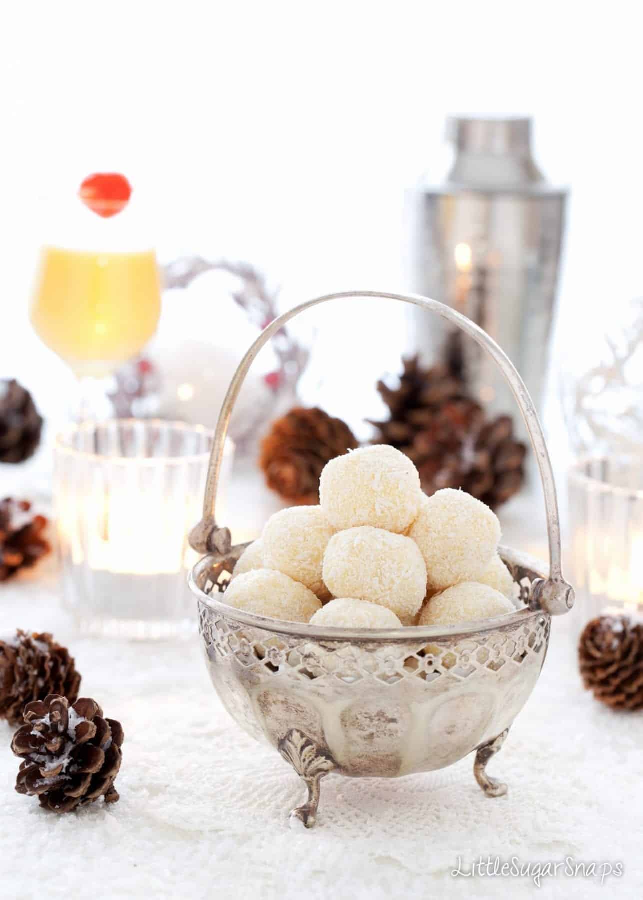 Snowball Truffles served in a small sliver candy dish with a handle.