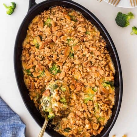 Overhead Traditional Cheesy Broccoli Casserole with a serving spoon in it.