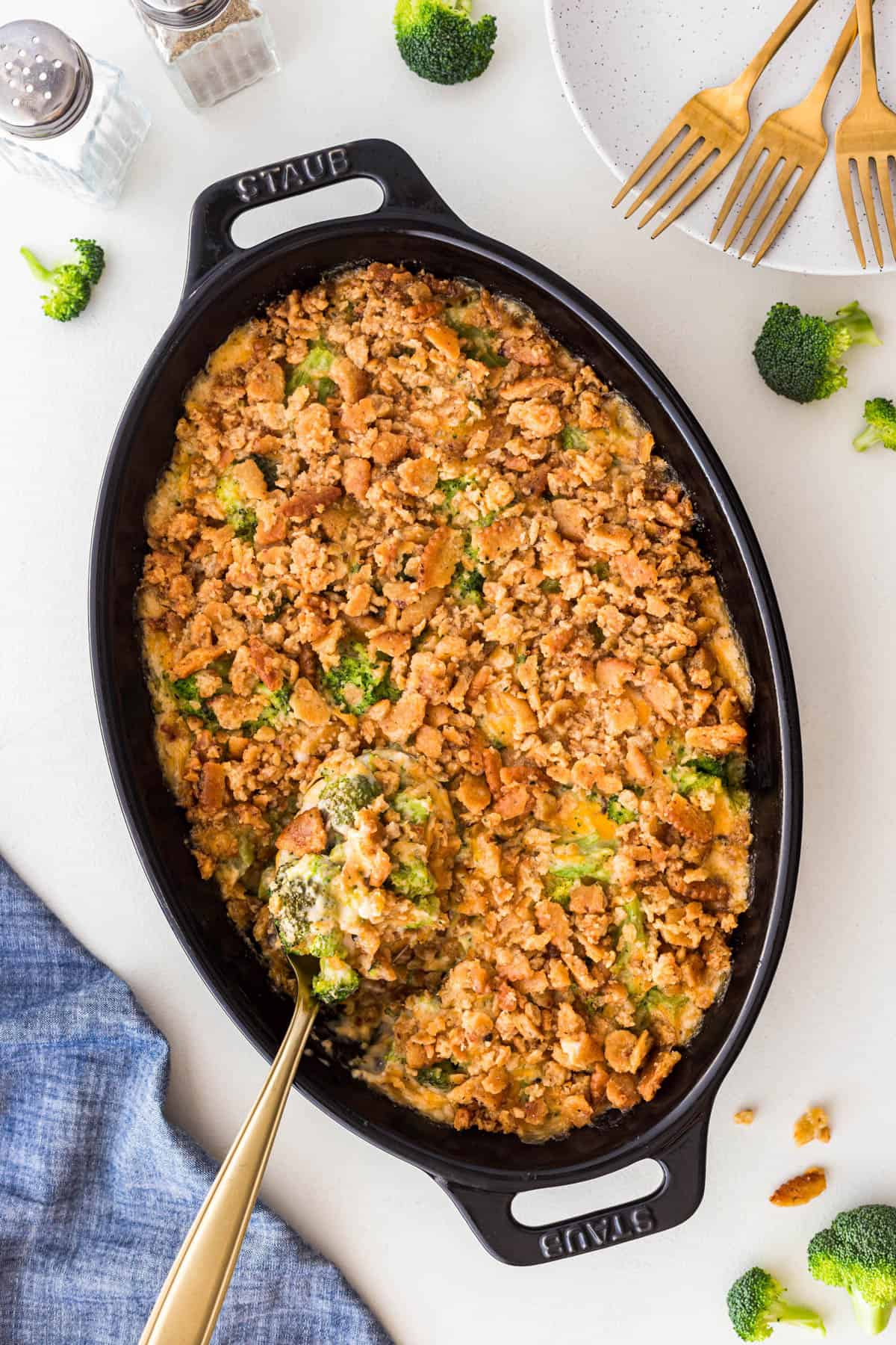 Overhead Traditional Cheesy Broccoli Casserole with a serving spoon in it. 