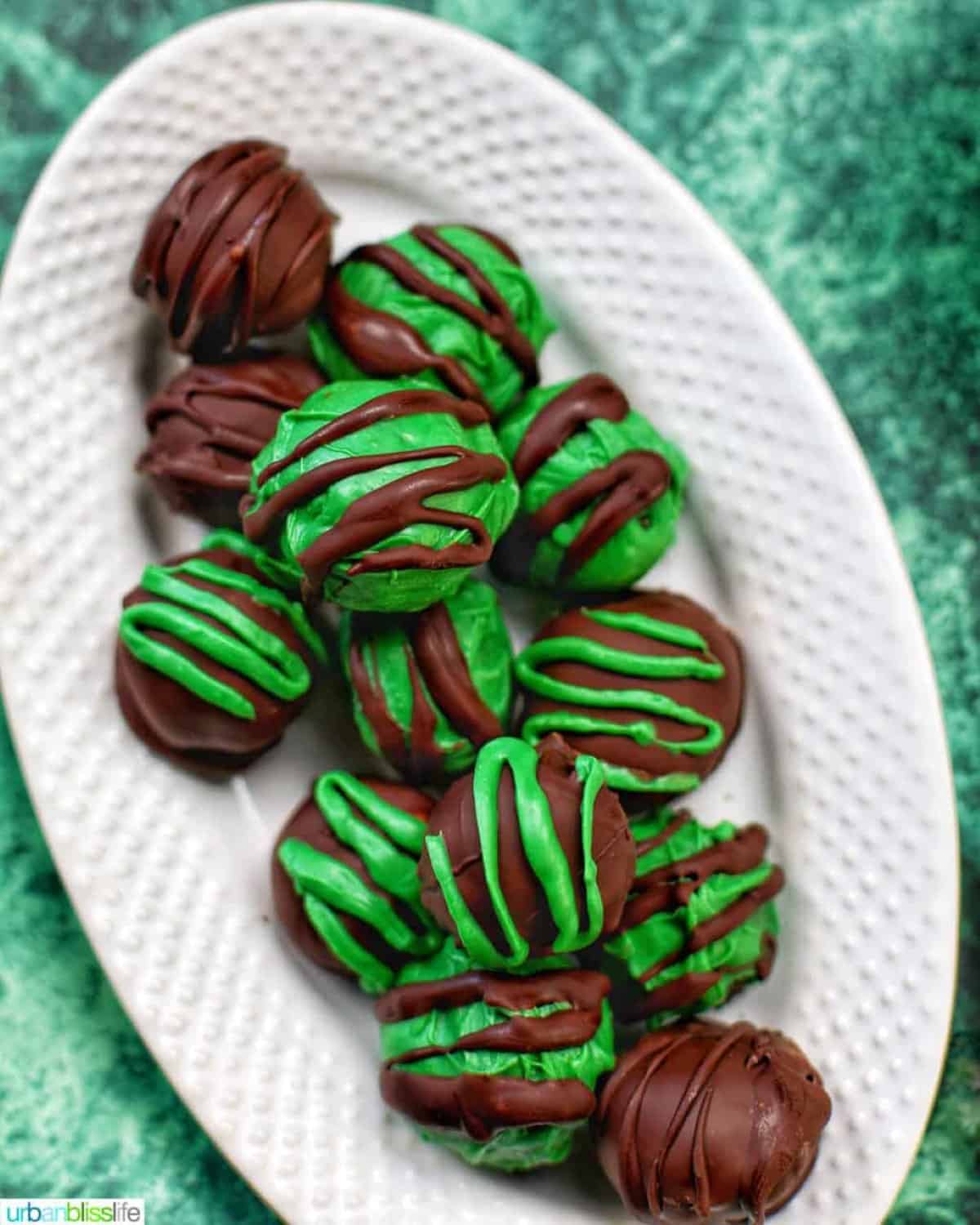 Mint Oreo Truffles served on an oval white platter.