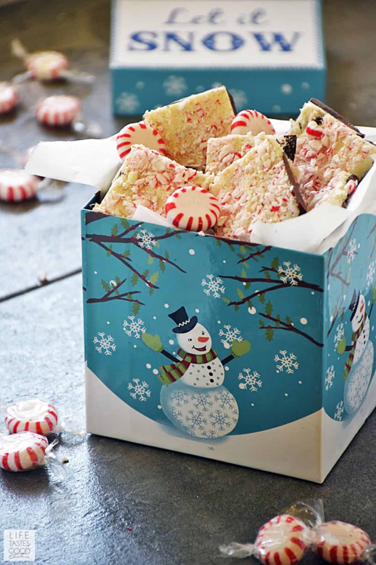 Peppermint Bark Candy in a Christmas box with a snowman on it.