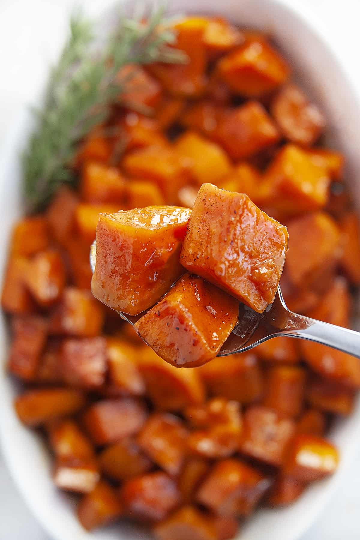 Close-up spoonful of candied yams. 