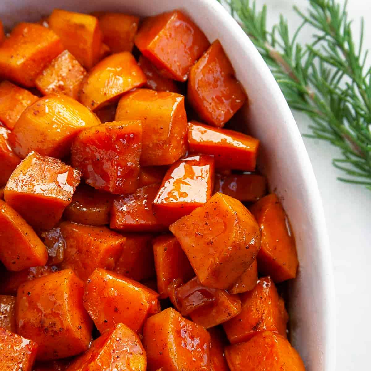 Square photo of candied yams in a casserole dish. 