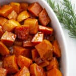 Overhead shot of candied yams in an oval white casserole dish.