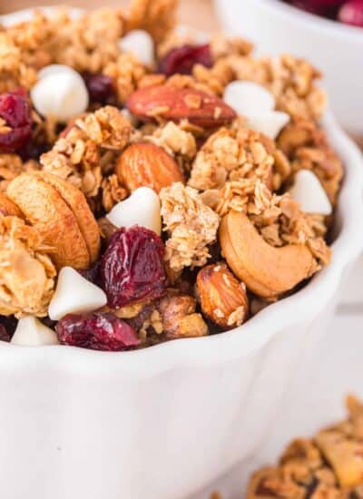Closeup of Christmas Granola: Cranberry White Chocolate in a white bowl.