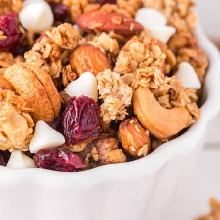 Closeup of Christmas Granola: Cranberry White Chocolate in a white bowl.