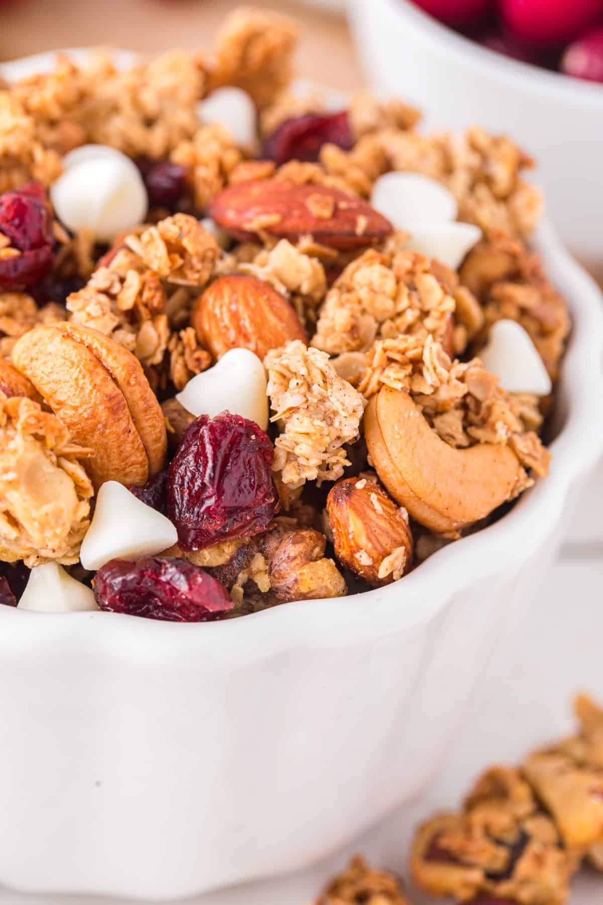 Closeup of Christmas Granola: Cranberry White Chocolate in a white bowl. 