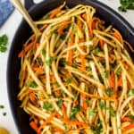 Overhead picture of Pan-Fried Carrot and Parsnip Recipe in a casserole with a spoon.