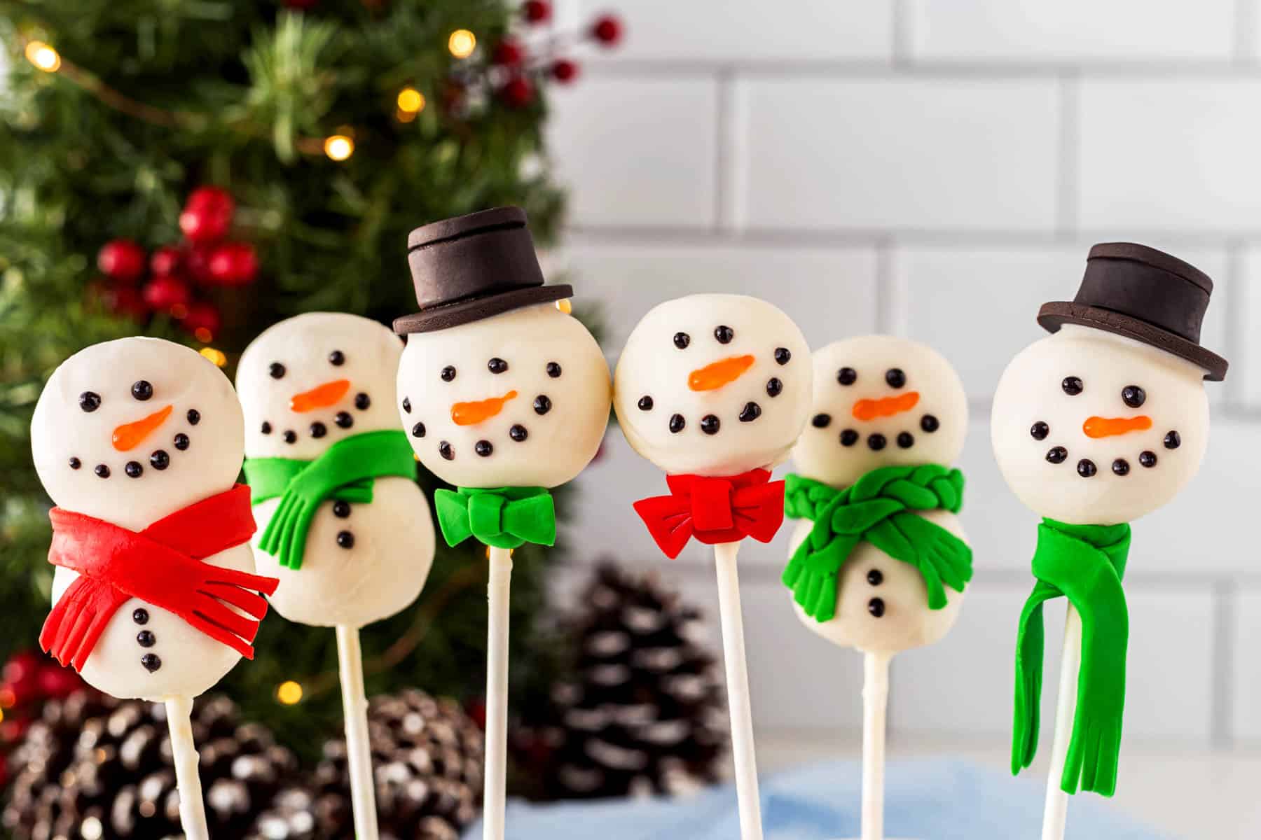 Horizontal line up of cute snowman cake pops.