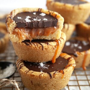 Chocolate Caramel Cookie Cups stacked with the top having a bite taken.