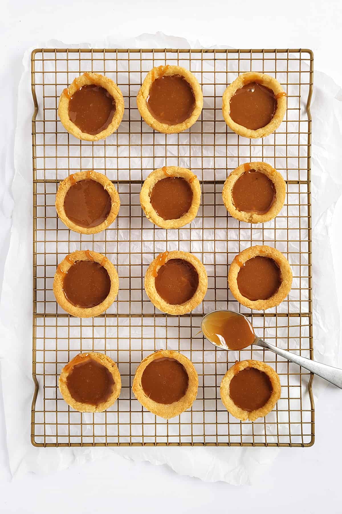 Overhead shot of cookie cups filled with caramel. 
