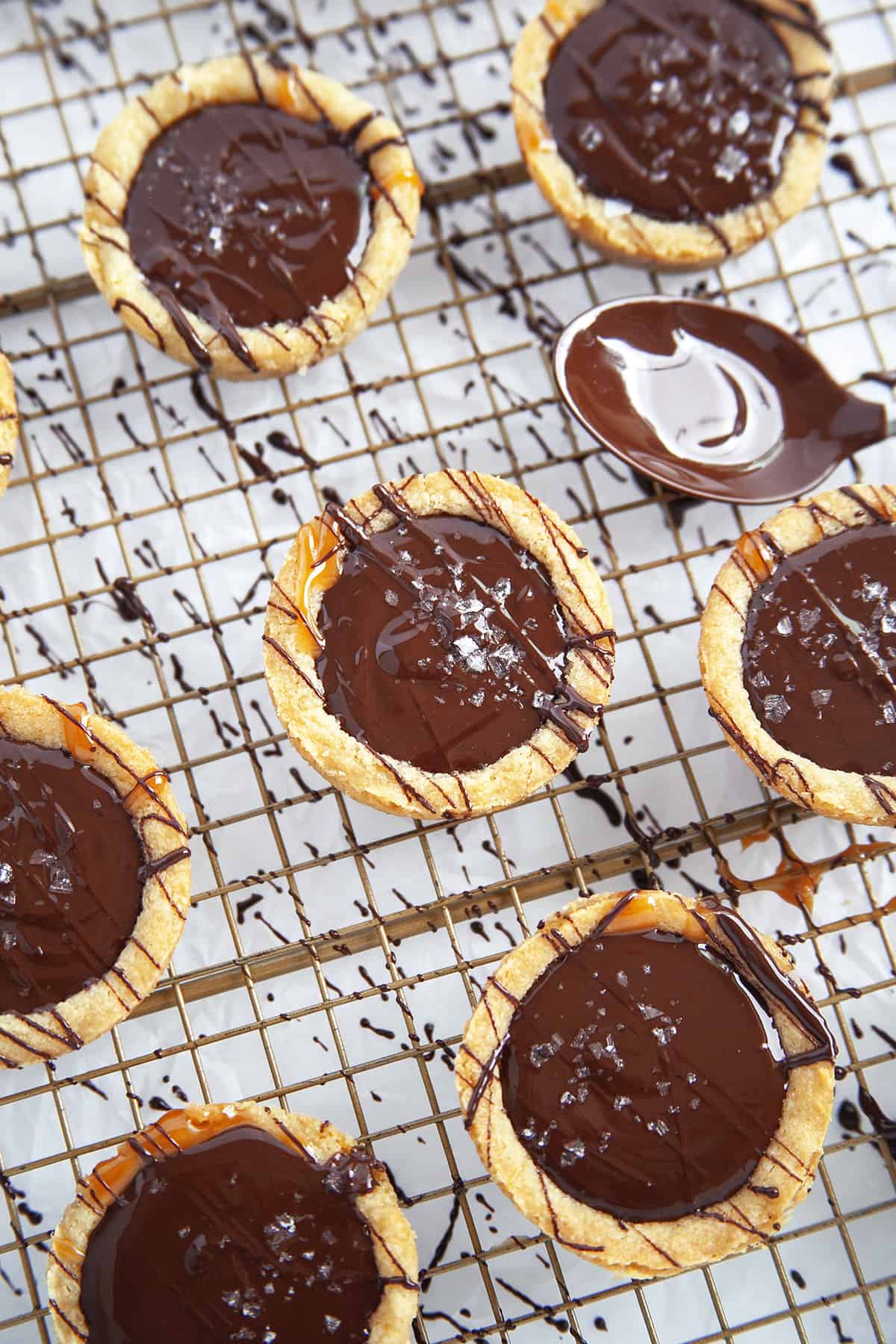 Showing freshly filled cookie cups with chocolate and topped with sea salt. 