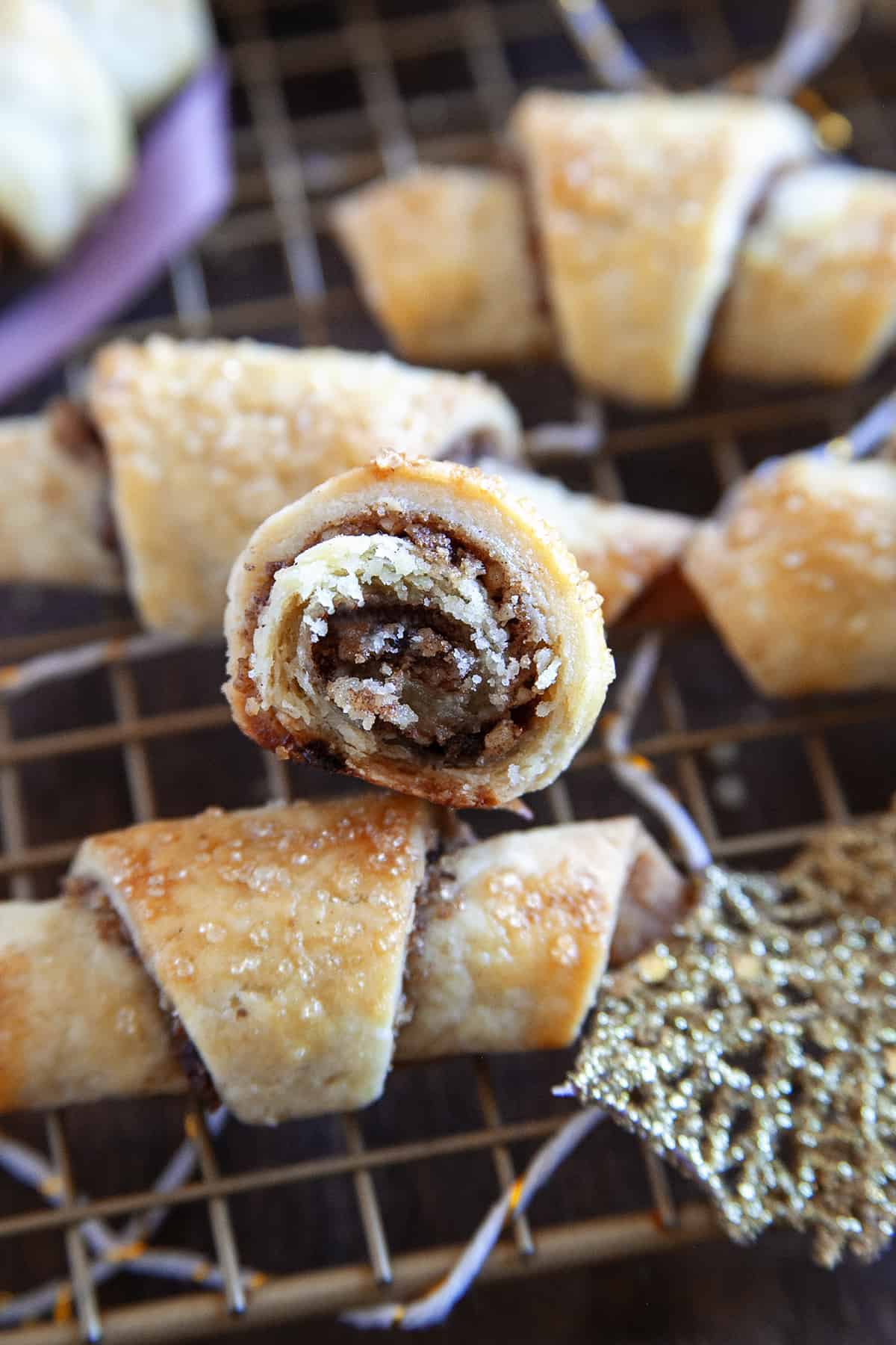 Rugelach on a cooking rack showing the inside of one of the rugelach. 