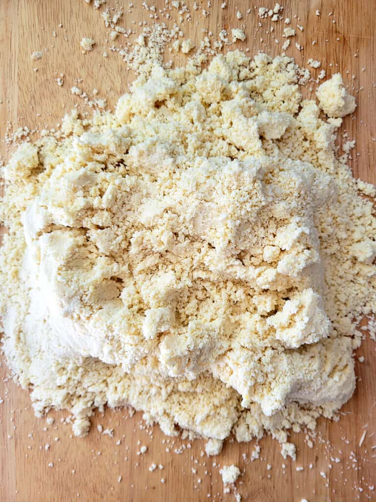 Crumbly dough on a board. 