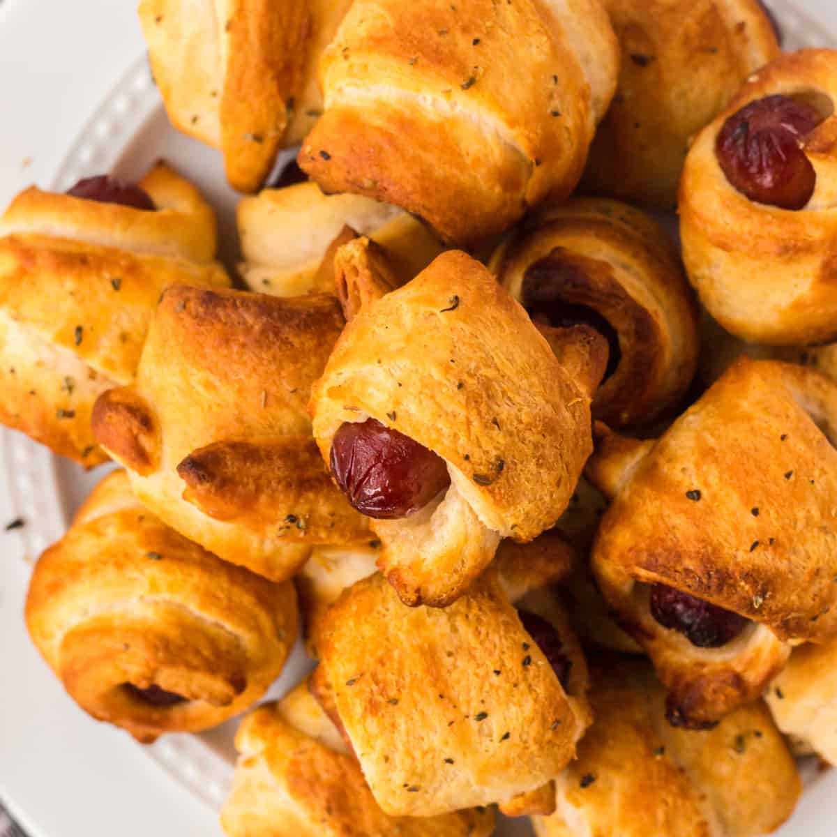 Square photo of pigs in a blanket close-up. 