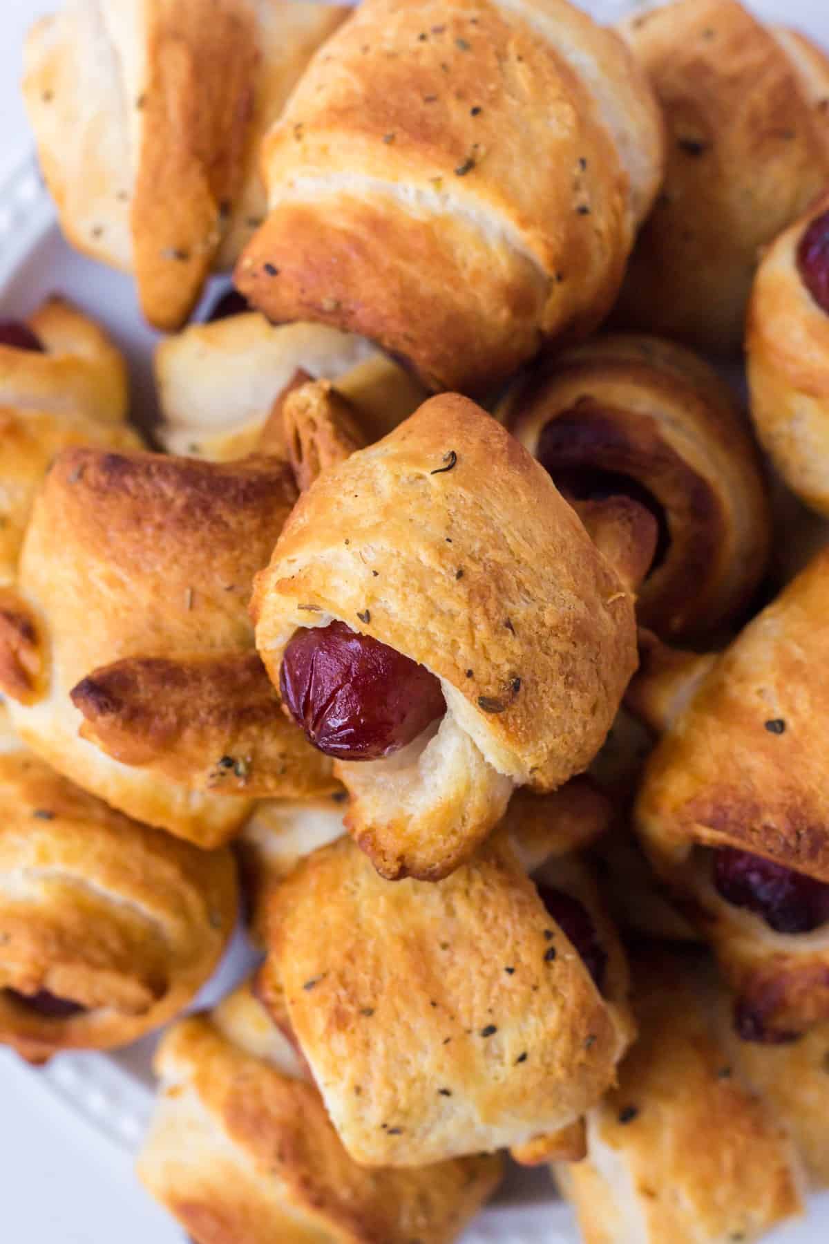 Close-up shot of pigs in a blanket stacked on each other. 