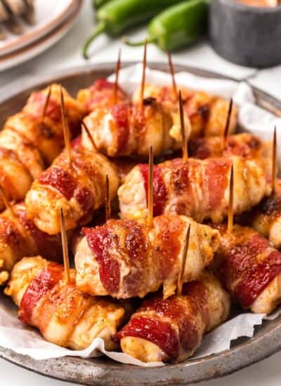 Bacon Wrapped Chicken Bites stacked on a platter.