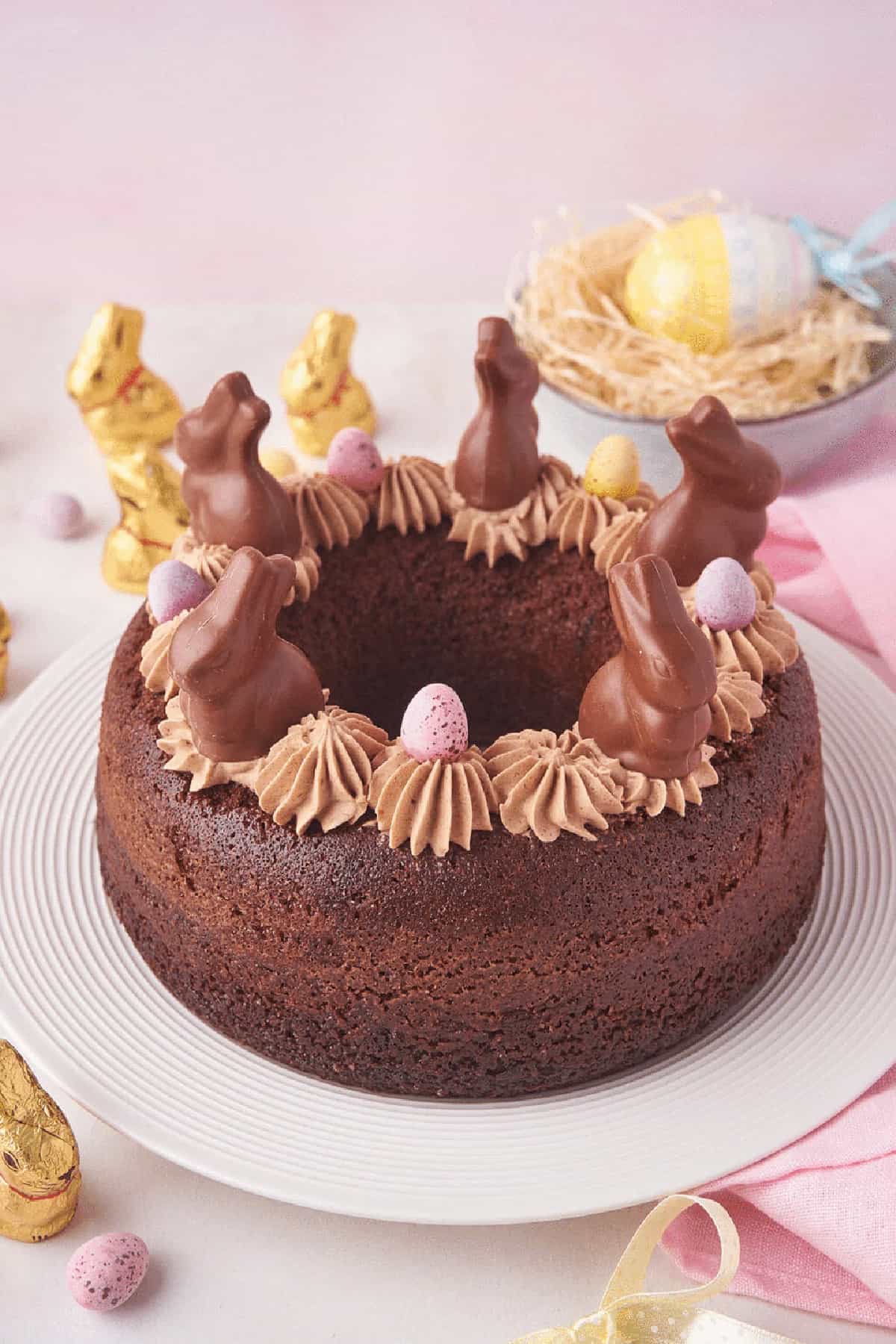 Easter bundt cake with chocolate icing, bunnies and eggs on top. 
