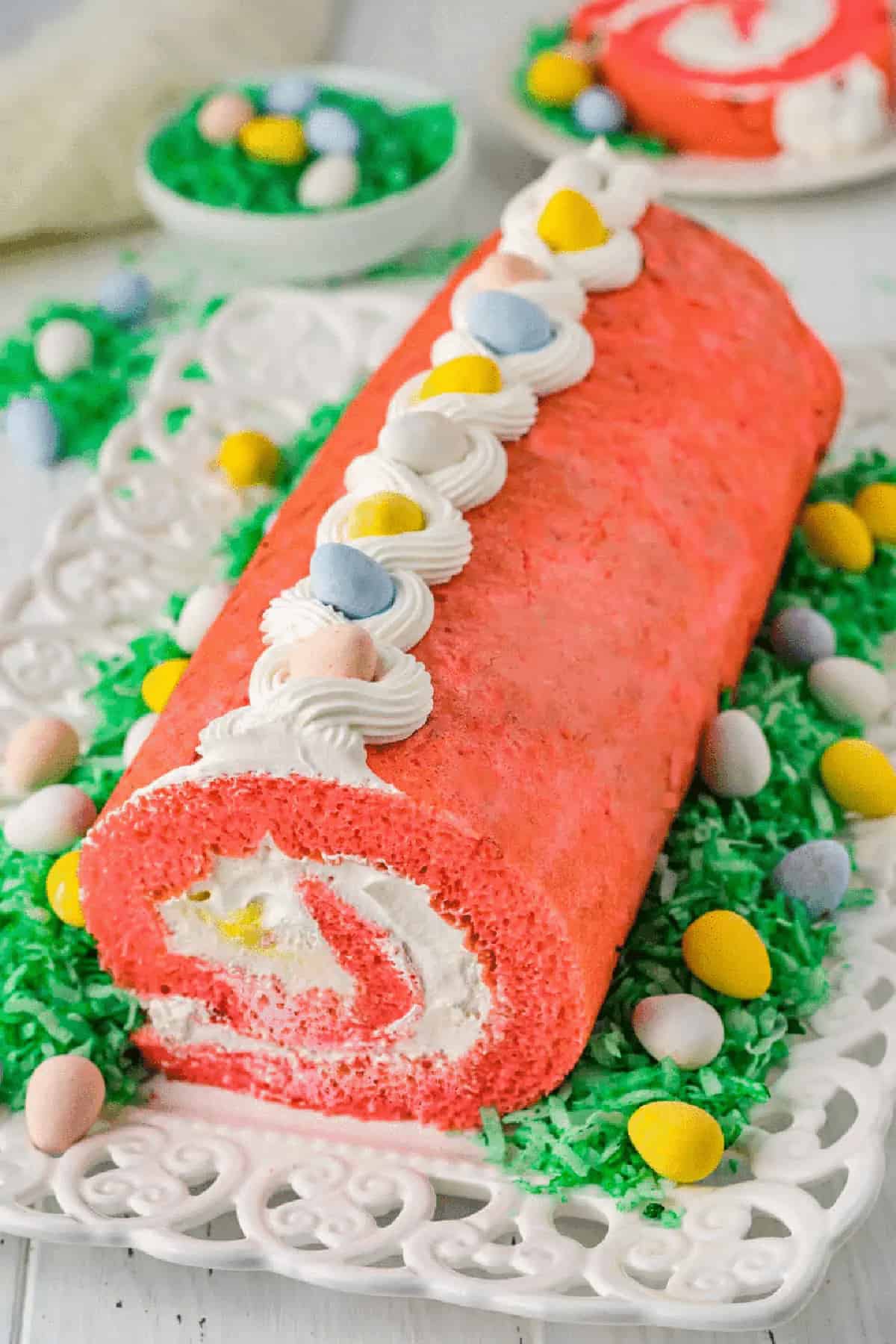 Easter cake roll with whipped cream and eggs on top. 