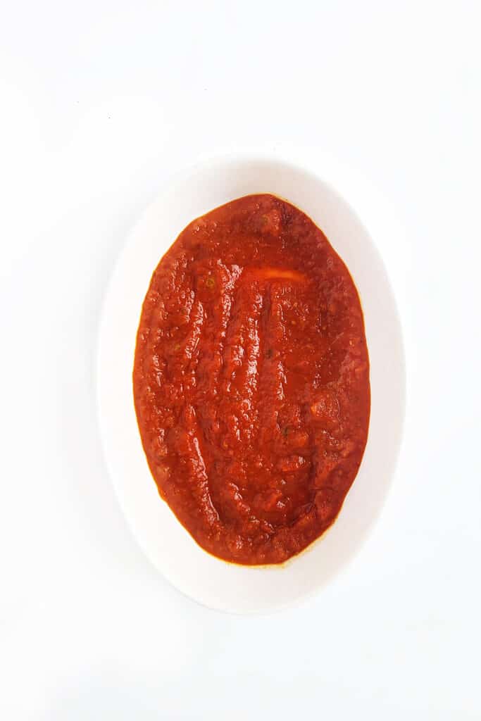 Marinara sauce in a baking dish. 