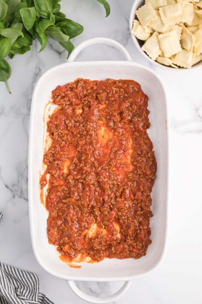 Meat sauce added to the bottom of a rectangle casserole.