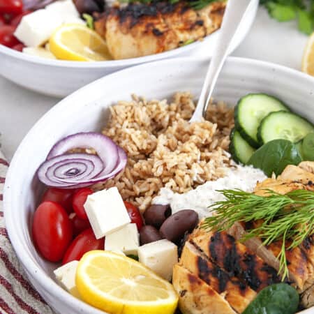Bowls of Greek Chicken and fixings.
