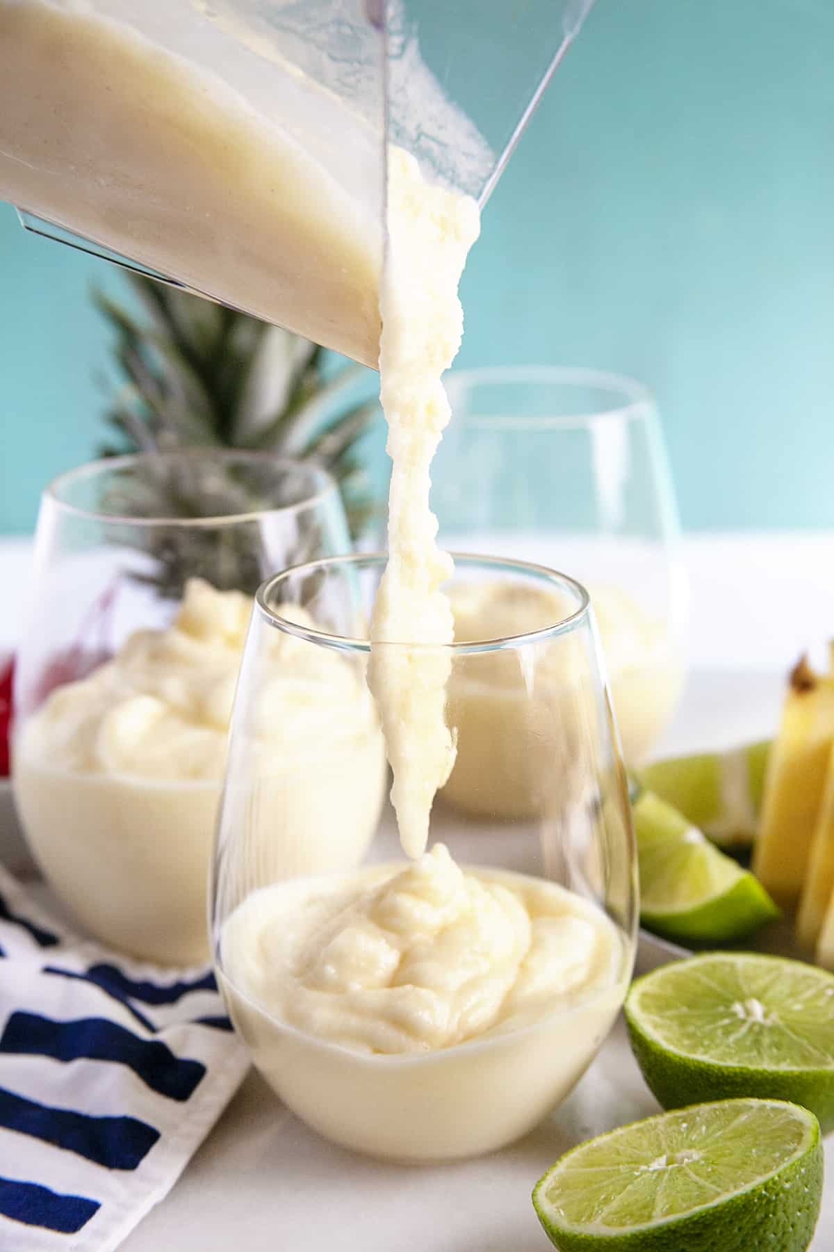 Pouring thick and icy pina colada into a glass. 